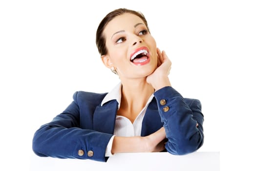 smiling attractive businesswoman showing blank signboard,over white background isolated