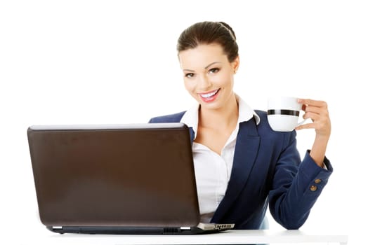 beautiful brunette businesswoman working on laptop computer isolated on white