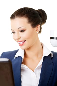 beautiful brunette businesswoman working on laptop computer isolated on white