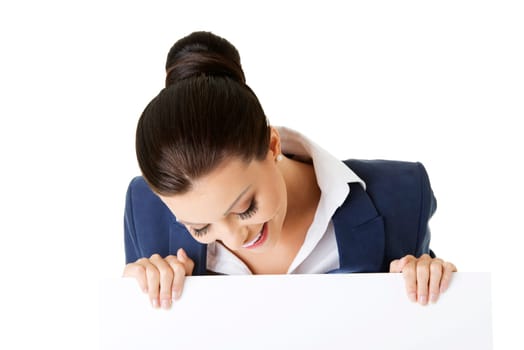 smiling attractive businesswoman showing blank signboard,over white background isolated