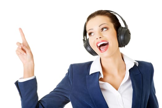 happy attractive businesswoman listening the music through headphones. isolated on white.
