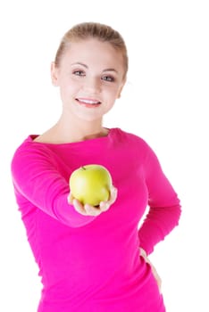 young woman holding green fresh apple in hand,isolated over white background