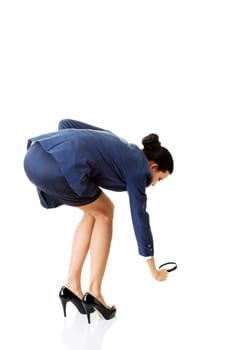 young attractive business woman looking into a magnifying glass,isolated on white background