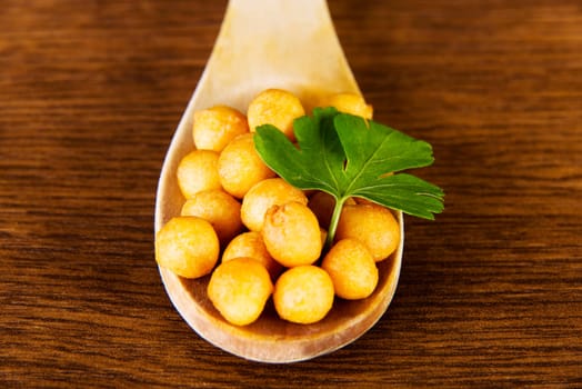 soup pearls backerbsen on wooden spoon