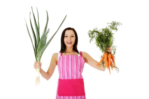 happy,excited woman in apron holding fresh leek and carrot