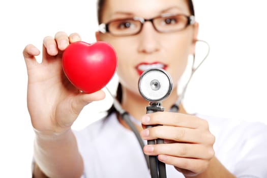 young female doctor with heart in her hand. isolated on white