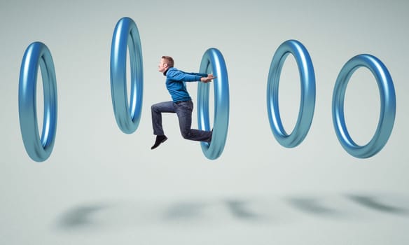 caucasian man jump in a metal 3d ring