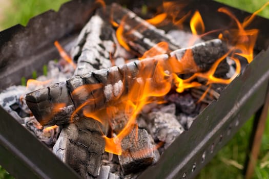 flames in the grill and coals