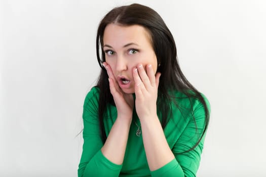 Surprised girl. Studio photo on white background