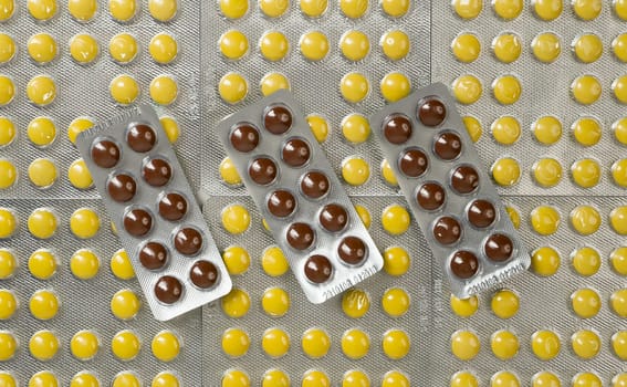 many pills of different colors in blister packs