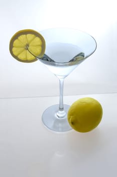 Martini glass with lemon slice and lemon from above