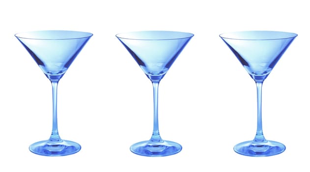 Three blue empty martini glasses in a row isolated