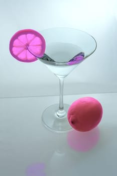 Martini glass with pink lemon slice and pink lemon from above