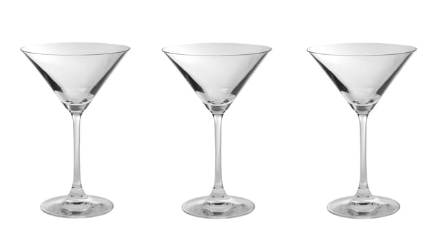 Three empty martini glasses in a row isolated