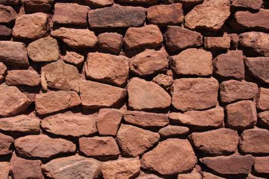 Background of reddish natural stone wall