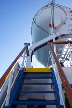 Vertical shot of stairs to a lifeboat on a ferry