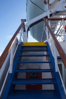 Vertical shot of stairs to a lifeboat on a ferry