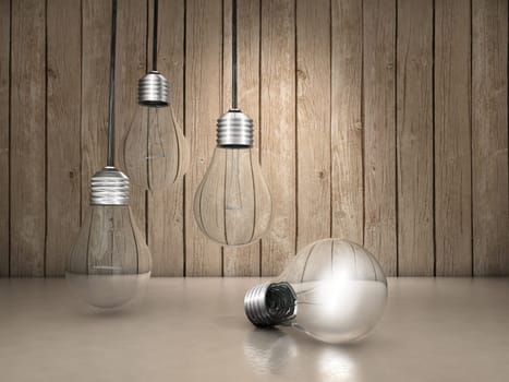 Three light bulbs hanging and one lighted up on the floor