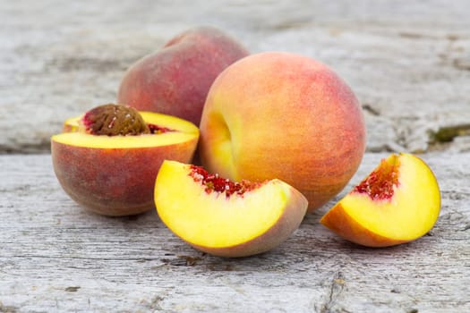 fresh peaches on old wooden background