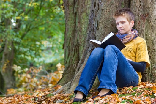 Woman reading book in the park