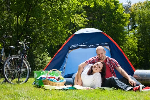 Happy young couple is relaxing on a camping