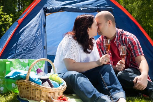 Happy young couple is relaxing on a camping