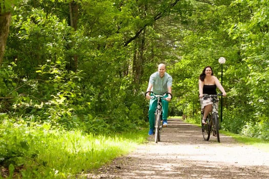 Happy young couple is taking a ride on a bicicle