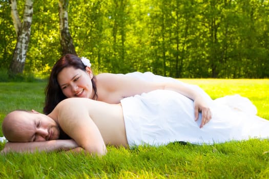 Happy young couple dressed white in the nature