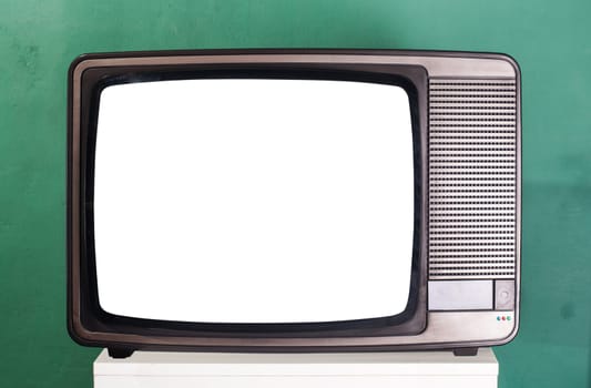 Old television, green wall on the background
