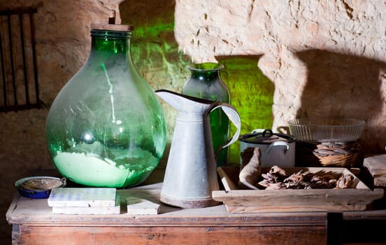 Photo of an iron pitcher and glass demijohn