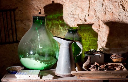Photo of an iron pitcher and glass demijohn