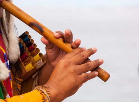 Peruvian Man In Native Costume Playing flute