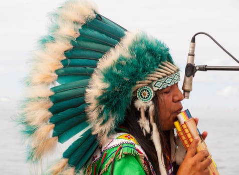 TRIESTE, ITALY - 14 DECEMBER 2012:Native american playing flute