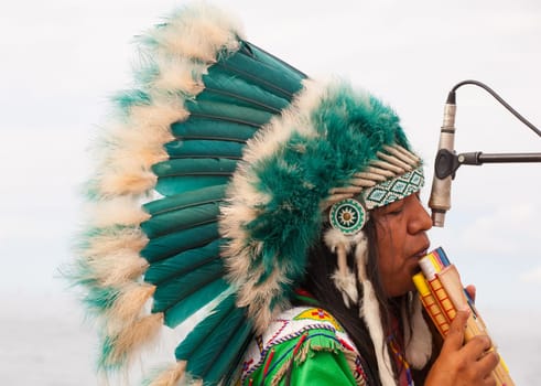 TRIESTE, ITALY - 14 DECEMBER 2012:Native american playing flute