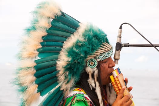 TRIESTE, ITALY - 14 DECEMBER 2012:Native american playing flute