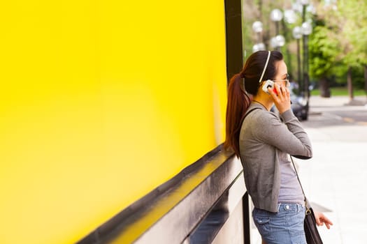 Teenager oriental girl on yellow wall. Fuori salone, Triennale - Mini car exhibition- .http