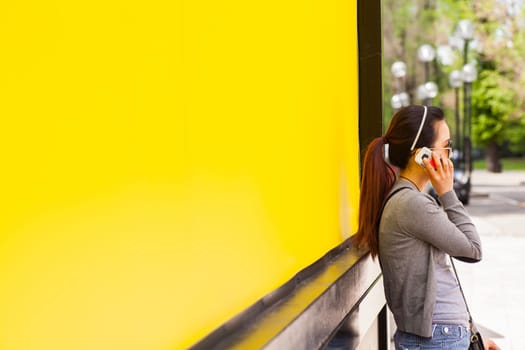Teenager oriental girl on yellow wall. Fuori salone, Triennale - Mini car exhibition- .http