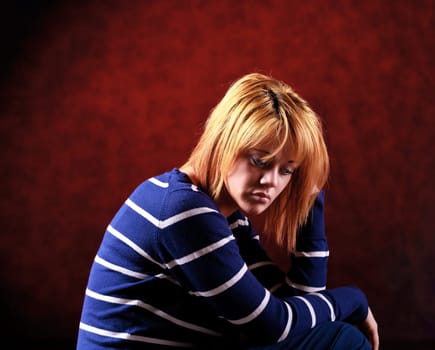 Girl sitting on the stool on red background