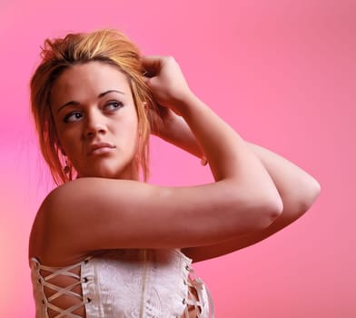 Sensual blonde girl on pink background