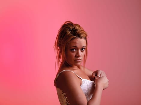 Sensual blonde girl on pink background