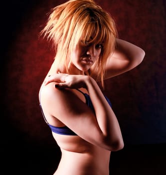 Sensual blonde girl in underwear on dark background