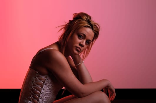 Sensual blonde girl on pink background