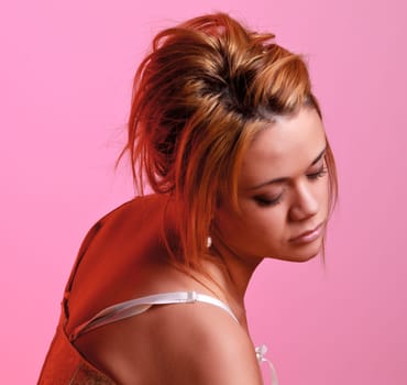 Sensual blonde girl on pink background