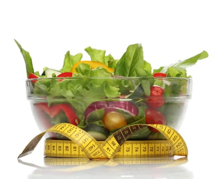 Healthy salad and a measuring tape isolated