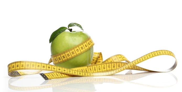 Healthy green apple and a measuring tape isolated