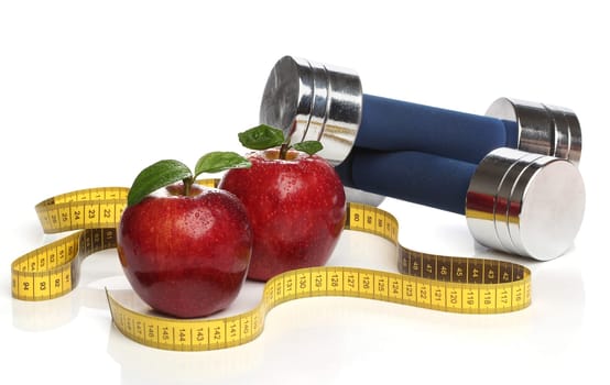 Red apples and a measuring tape over white