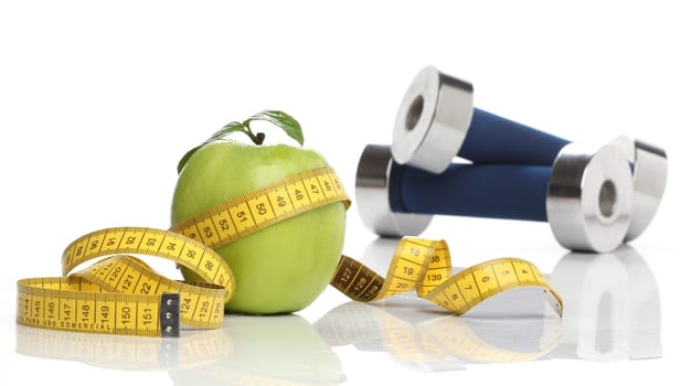 Healthy green apple and a measuring tape isolated