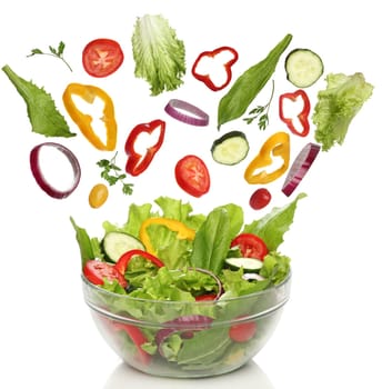 Falling fresh vegetables. Healthy salad isolated