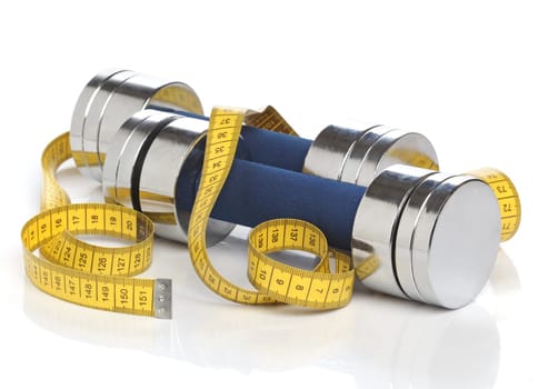 Dumbbells and a measuring tape over white