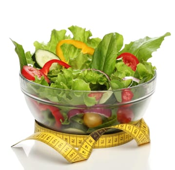 Healthy salad and a measuring tape isolated